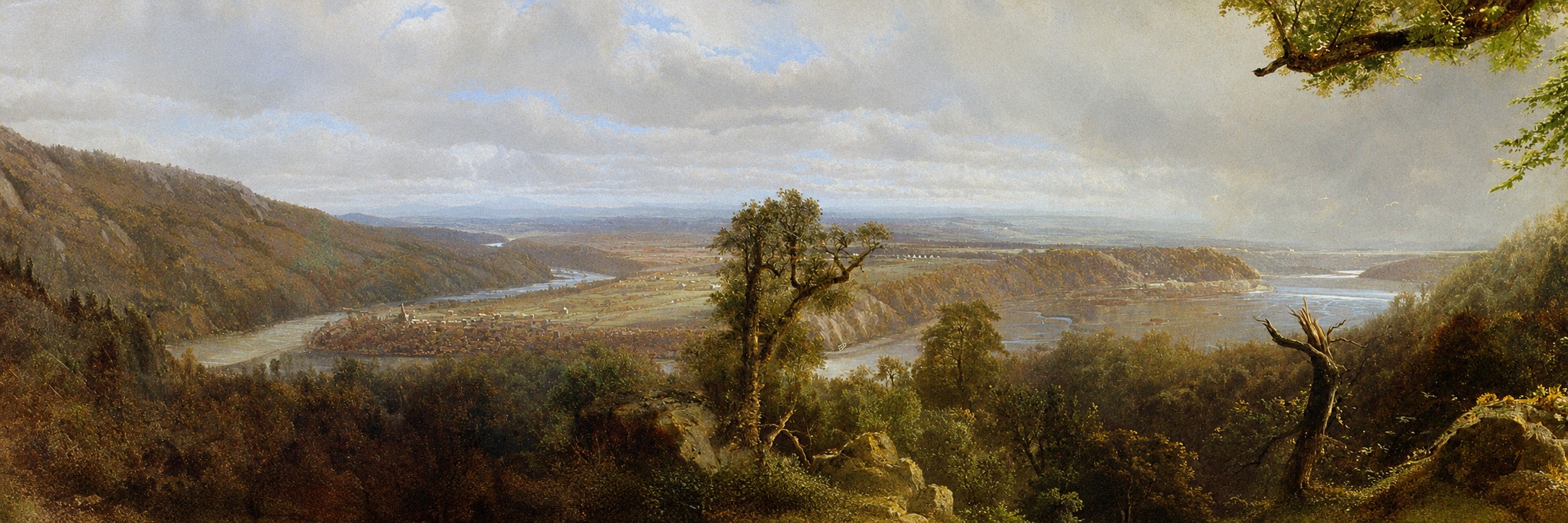 Wide landscape with open terrain stretching toward the horizon under soft light